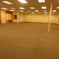 Photograph of men's prayer space in masjid, looking towards back