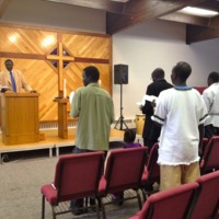 Wal Reat leading a congregation